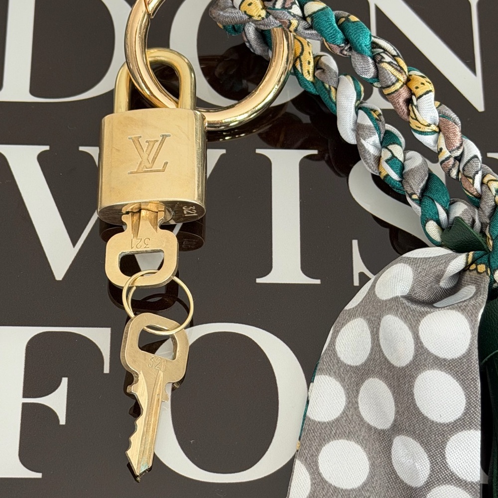 Authentic Louis Vuitton Padlock with keys and unbranded multi purpose keychain.